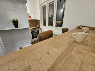a kitchen with a wooden table in a room at Studio 1920 in Belgrade
