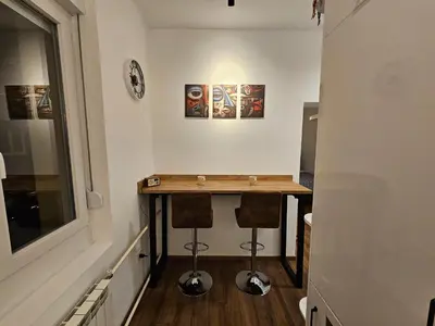 a small room with a table and two stools at Studio 1920 in Belgrade