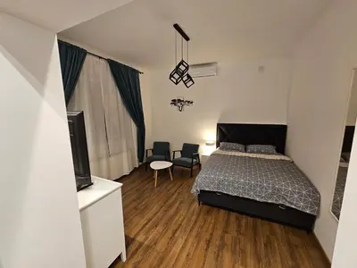 a bedroom with a bed and a flat screen tv at Studio 1920 in Belgrade
