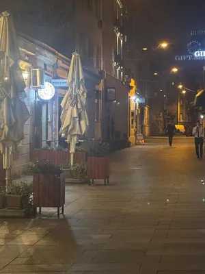 an empty street at night with umbrellas at Bohemian Rhapsody low ground studio in Belgrade