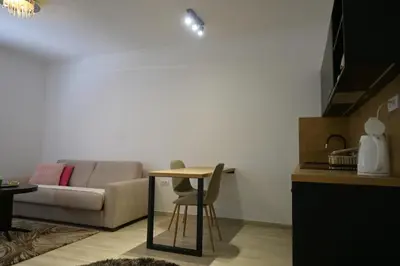 a living room with a table and a couch at Ellie Star Apartment in Belgrade