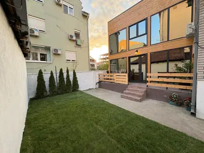 a house with a lawn in front of it at Beli Bor in Vračar (historical)