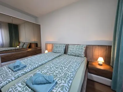 a bedroom with a bed with blue towels on it at BW Quartet 302 deluxe apartments in Belgrade