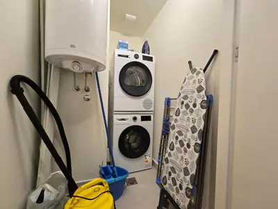 a laundry room with a washing machine and a washer at BW Quartet 302 deluxe apartments in Belgrade