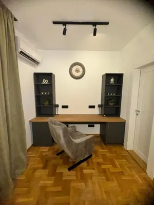 a office with a desk and a chair in a room at Fairy tale apartment 9 in Voždovac