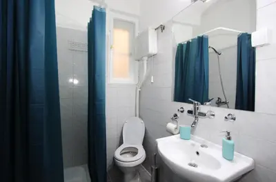 a bathroom with a sink and a toilet and a mirror at Apartman Savka in Belgrade