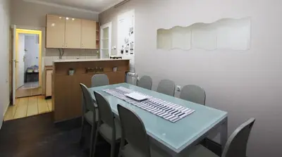 a dining room and kitchen with a table and chairs at Apartman Savka in Belgrade