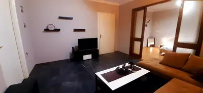 a living room with a couch and a table at Apartman Savka in Belgrade