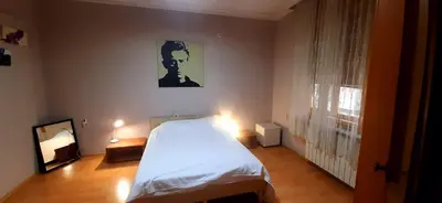 a bedroom with a white bed and a window at Apartman Savka in Belgrade