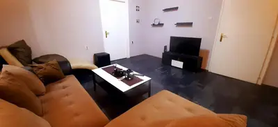 a living room with a couch and a coffee table at Apartman Savka in Belgrade