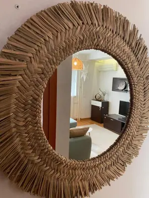a large circular mirror hanging on a wall in a living room at Belgrade Blue Oasis in Belgrade