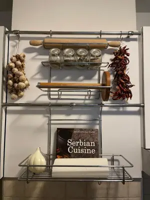 a metal shelf with a book and a baseball bat at Belgrade Blue Oasis in Belgrade