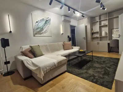 a living room with a couch and a table at Urban Central Stay Belgrade in Belgrade