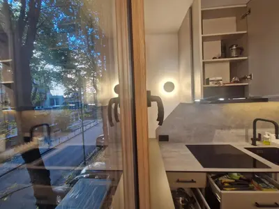 a kitchen with a view of a street through a window at Urban Central Stay Belgrade in Belgrade