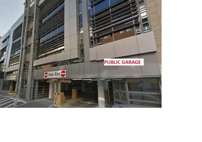 a large building with a sign that reads public garage at Urban Central Stay Belgrade in Belgrade