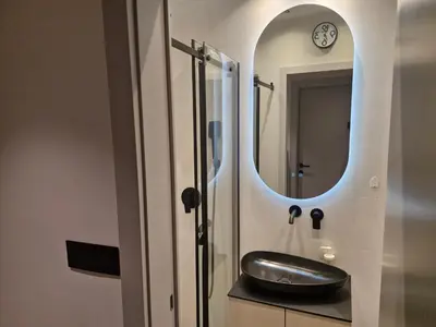 a bathroom with a sink and a mirror at Urban Central Stay Belgrade in Belgrade