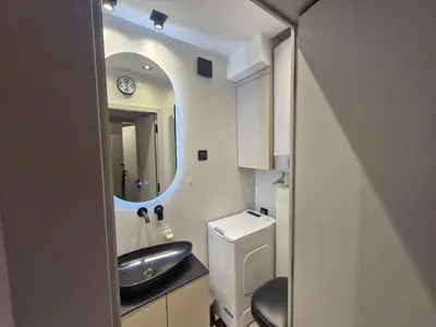a small bathroom with a sink and a mirror at Urban Central Stay Belgrade in Belgrade