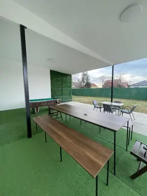a group of tables and chairs under a white tent at Apartman na dan Pecinci in Pećinci