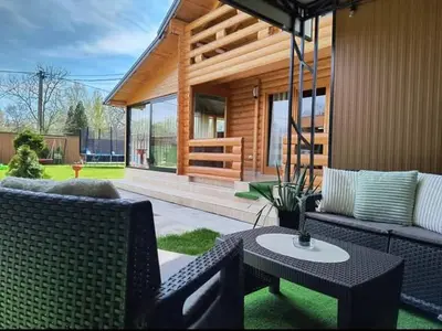 a house with a patio with a table and chairs at Brvnara Balorig in Barič