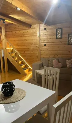 a living room with a table and a couch at Brvnara Balorig in Barič