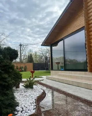 a house with glass windows and a rock garden at Brvnara Balorig in Barič