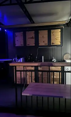 a large wooden table in a room with a blue light at Brvnara Balorig in Barič