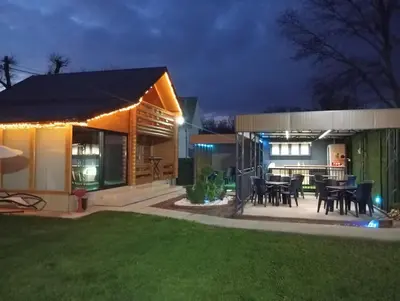 a home with a patio and dining area at night at Brvnara Balorig in Barič
