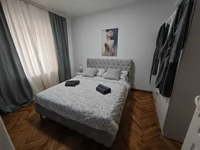 a bedroom with a bed with two pillows on it at NeNa Apartmani - Ruma in Ruma