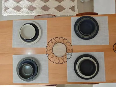 a table with black and white plates on it at NeNa Apartmani - Ruma in Ruma