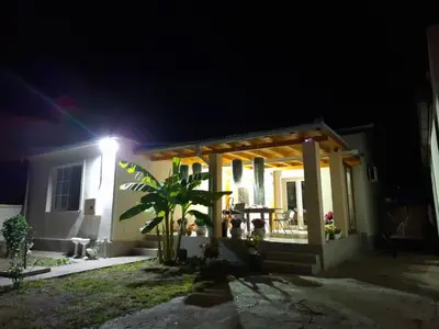 a house with a light on the front of it at night at NeNa Apartmani - Ruma in Ruma