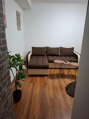 a living room with a couch and two tables at NeNa Apartmani - Ruma in Ruma