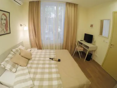 a bedroom with a bed and a desk at Bed&Breakfast kod Smilje in Belgrade