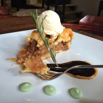 a piece of pie with ice cream on a plate with a fork at Bed&Breakfast kod Smilje in Belgrade