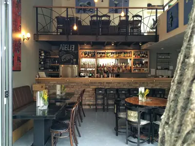 a restaurant with tables and chairs and a bar at Bed&Breakfast kod Smilje in Belgrade