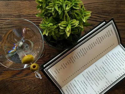 a book on a table next to a vase with a plant at Bed&Breakfast kod Smilje in Belgrade