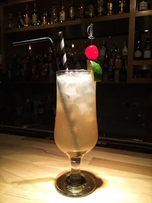 a drink with a martini with a red ball in it at Bed&Breakfast kod Smilje in Belgrade
