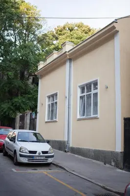 a white car parked in front of a building at Bed&Breakfast kod Smilje in Belgrade