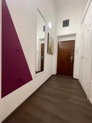 a hallway with a door and a mirror at Skadarlija Residence in Belgrade