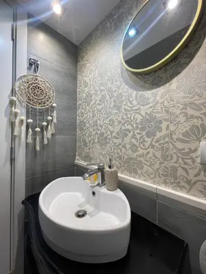 a bathroom with a sink and a mirror on the wall at Skadarlija Residence in Belgrade