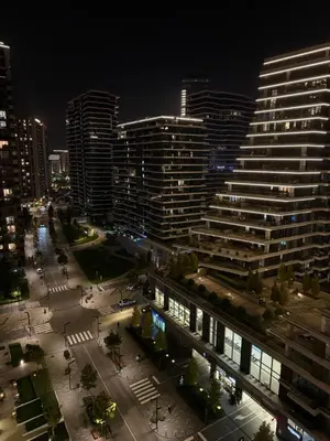 a view of a city at night with tall buildings at Belgrade Waterfront Sky & River View Residences in Belgrade