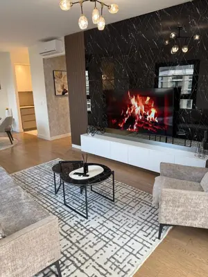 a living room with a fireplace and a couch at Belgrade Waterfront Sky & River View Residences in Belgrade