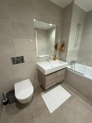 a bathroom with a toilet and a sink and a tub at Belgrade Waterfront Sky & River View Residences in Belgrade