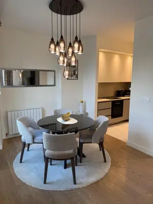 a dining room with a black table and chairs at Belgrade Waterfront Sky & River View Residences in Belgrade