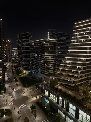 a city skyline at night with tall buildings at Belgrade Waterfront Sky & River View Residences in Belgrade