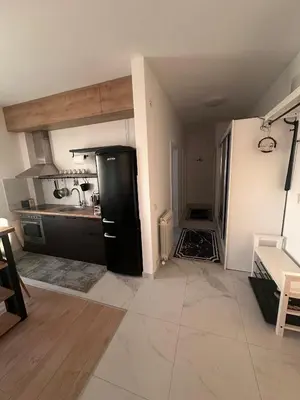 a kitchen with a black refrigerator in a room at Apartman 601 in Surčin