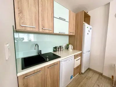 a small kitchen with a sink and a refrigerator at Cozy apartments in Belgrade, Čukarica, Železnik, free parking and WiFi in Belgrade