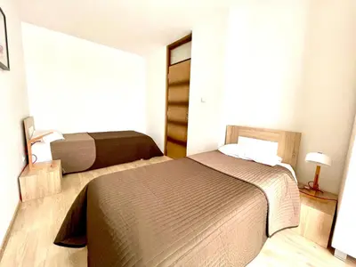 a bedroom with two beds and a window at Cozy apartments in Belgrade, Čukarica, Železnik, free parking and WiFi in Belgrade