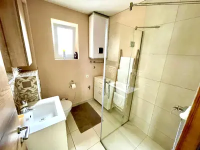 a bathroom with a shower and a toilet and a sink at Cozy apartments in Belgrade, Čukarica, Železnik, free parking and WiFi in Belgrade