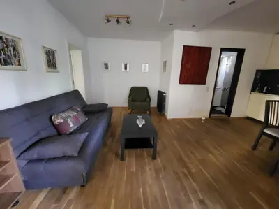 a living room with a couch and a table at Udobni smestaj in Belgrade
