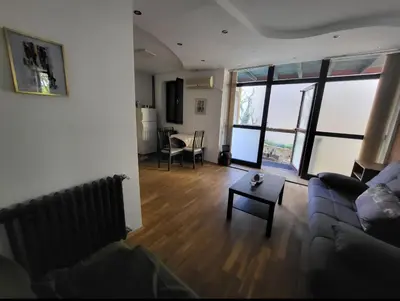 a living room with a couch and a table at Udobni smestaj in Belgrade